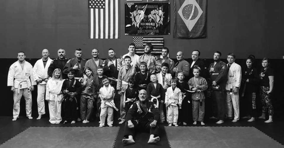 BJJ community group photo on the mats