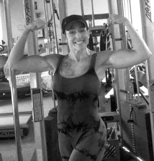 Tracy Koenig flexing at the gym